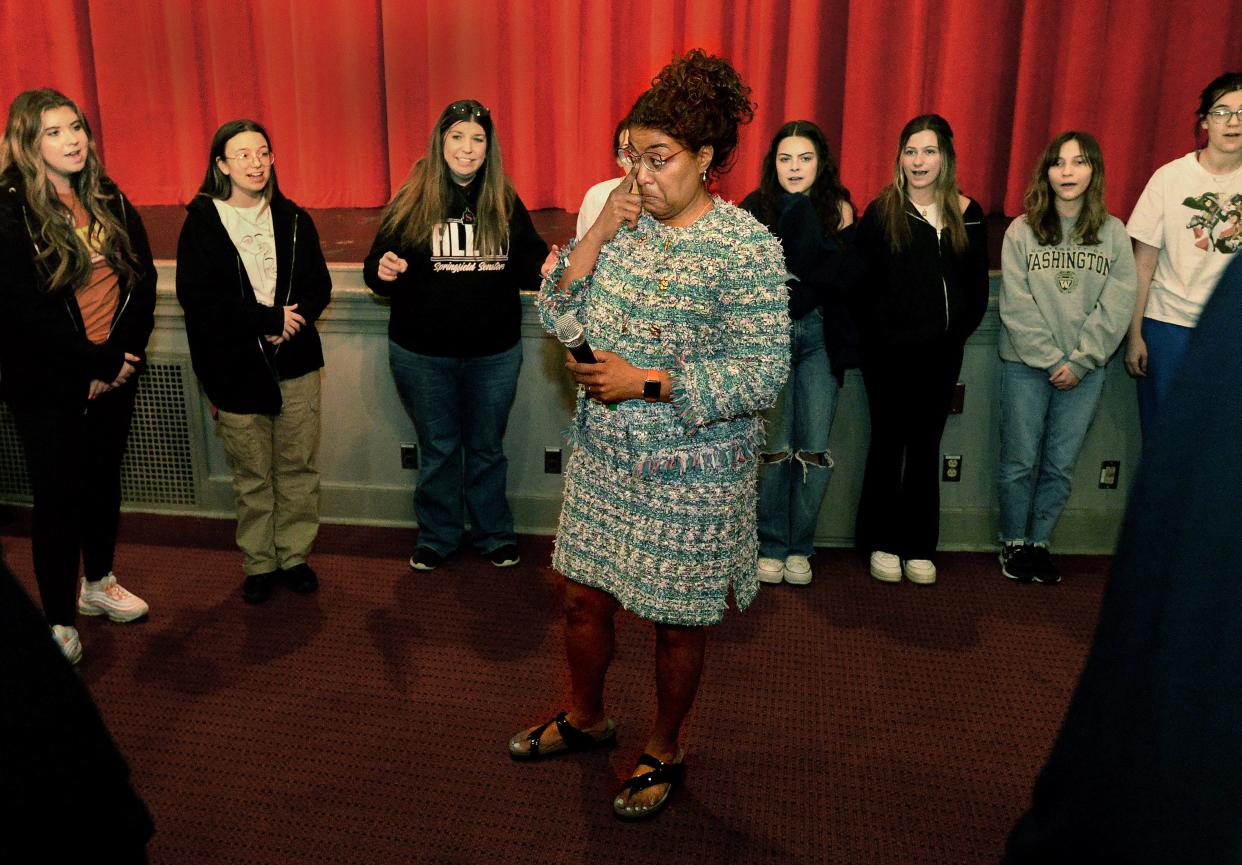 Tracey Meares wipes away a tear as she listens to Springfield High School's 7 & Senators sing the school alma mater to her at the school Thursday, April, 6, 2023. Meares was honored with the Distinguished Alumni Award.