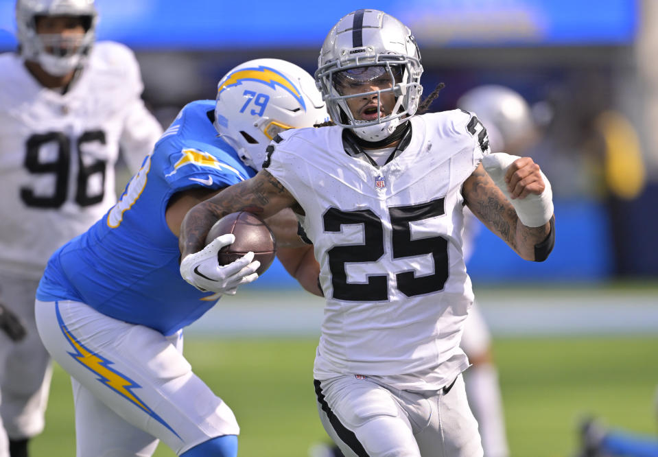 Oct 1, 2023; Inglewood, California, USA; Las Vegas Raiders safety Tre’von Moehrig (25) is forced out of bounds by Los Angeles Chargers offensive tackle <a class="link " href="https://sports.yahoo.com/nfl/players/31923" data-i13n="sec:content-canvas;subsec:anchor_text;elm:context_link" data-ylk="slk:Trey Pipkins;sec:content-canvas;subsec:anchor_text;elm:context_link;itc:0">Trey Pipkins</a> III (79) after an interception in the second half at SoFi Stadium. Mandatory Credit: Jayne Kamin-Oncea-USA TODAY Sports