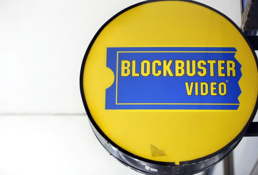 A round, yellow-and-blue Blockbuster Video store sign