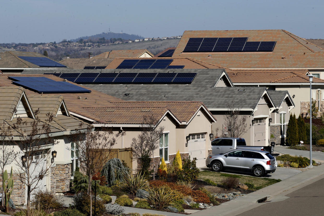 FILE—Solar panels sit on rooftops at a housing development in Folsom, Calif., Wednesday, Feb. 12, 2020. A plan released by the California Air Resources Board on Tuesday, May 10, 2022, says the state will need to dramatically increase its solar power to meet ambitious climate change goals. The plan says the state should reduce its reliance on petroleum by 91% by 2045. (AP Photo/Rich Pedroncelli, File)