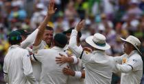 Australia's Peter Siddle (2nd L) celebrates with teammates after taking the wicket of England's Kevin Pietersen during the fourth day of the second Ashes test cricket match at the Adelaide Oval December 8, 2013.