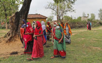 Women return to their village after attending an awareness program on getting tested and vaccinated against COVID-19 in Jamsoti village, Uttar Pradesh state, India, on June 10, 2021. India's vaccination efforts are being undermined by widespread hesitancy and fear of the jabs, fueled by misinformation and mistrust. That's especially true in rural India, where two-thirds of the country’s nearly 1.4 billion people live. (AP Photo/Rajesh Kumar Singh)