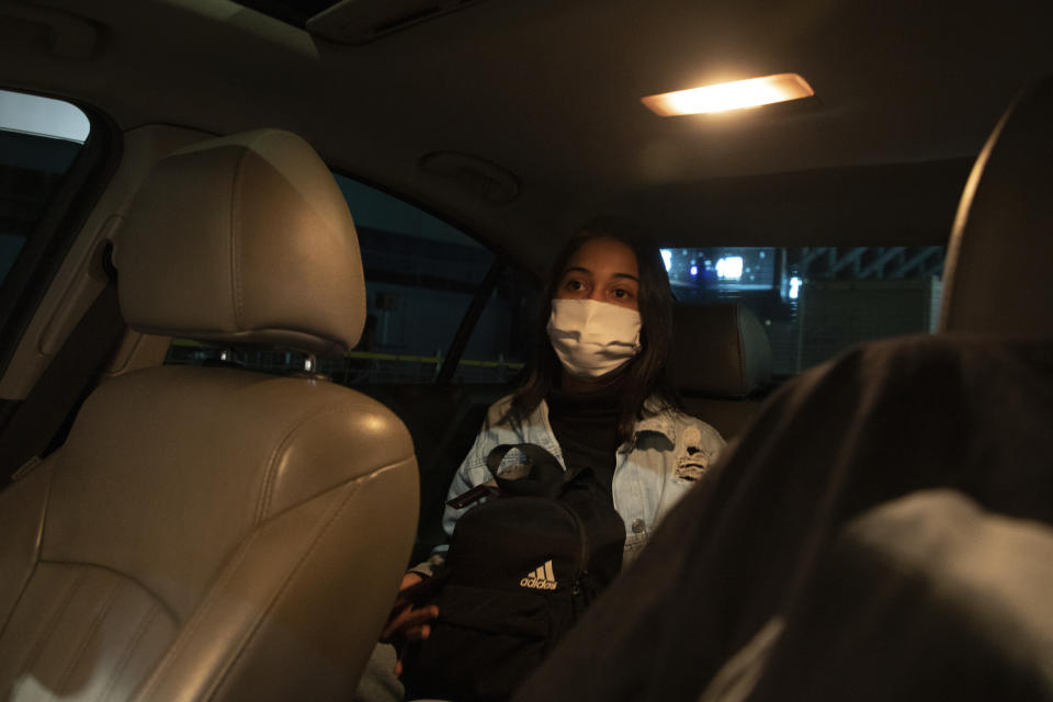 Sara leaves Ezeiza airport in a car upon arrival to Buenos Aires, Argentina, Sunday, Dec. 13, 2020, after flying in from Brazil. Brazilian women without means have started seeking abortions elsewhere in Latin America to dodge risks and legal obstacles in the region's most populous country. (AP Photo/Emiliana Miguelez)