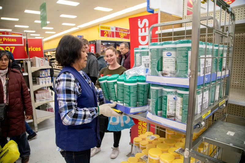 FILE PHOTO: People gather supplies at a grocery store amid coronavirus fears spreading in Toronto