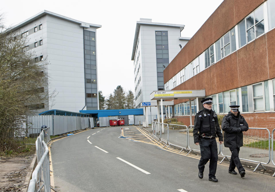 Police patrol outside the buildings at Arrowe Park Hospital, where passengers that have been repatriated to the UK from a cruise ship hit by the COVID-19 coronavirus in Yokohama, Japan, will be quarantined for 14 days to protect against the spread of the illness should any of them be infected, in Upton, England, Saturday Feb. 22, 2020.  The Diamond Princess cruise ship was stuck in quarantine off the coast of Yokohama, Japan, with 3,700 passengers and crew. (Danny Lawson/PA via AP)