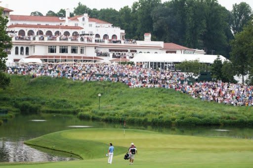 Rory McIlroy of Northern Ireland walks to the 18th green with his caddie J.P. Fitzgerald during the final round of the 111th US Open at Congressional Country Club in Bethesda, Maryland