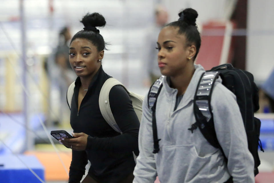 Simone Biles, left, and Zoe Miller arrive for training at the Stars Gymnastics Sports Center in Katy, Texas, Monday, Feb. 5, 2024. Biles begins preparations for the Paris Olympics when she returns to competition at the U.S. Classic in Hartford, Connecticut on Saturday. Biles, who cited mental health concerns while removing herself from several competitions at the Tokyo Olympics, says she is better prepared for the pressure competing presents this time around. (AP Photo/Michael Wyke)