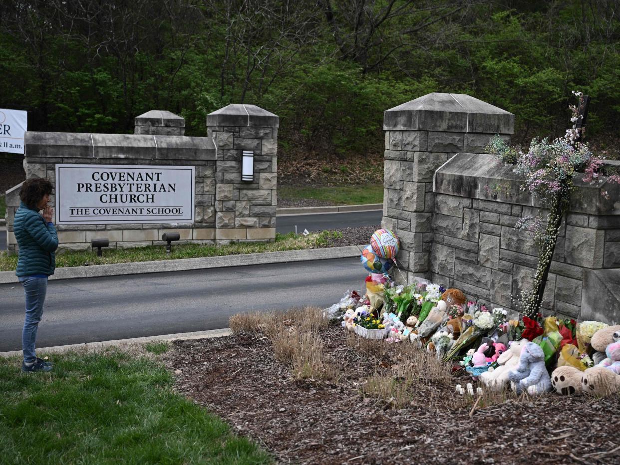 Robin Wolfenden prays at a makeshift memorial for victims outside the Covenant School building