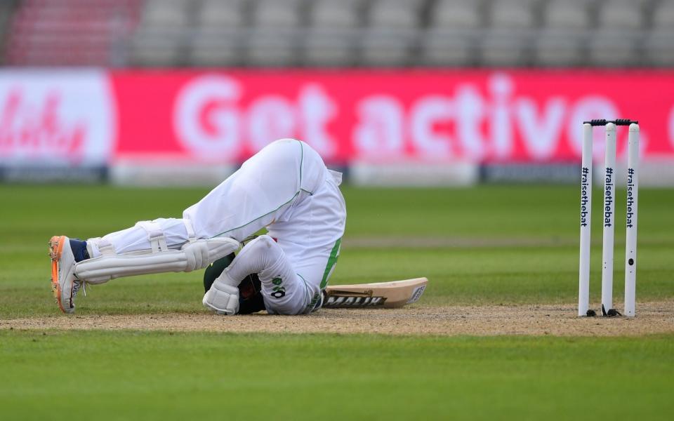 Azhar Ali of Pakistan falls over after getting out the way of a Jofra Archer bouncer over during Day Three  - GETTY IMAGES