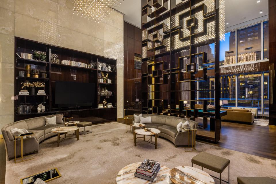 a seating area with a built-in bookshelf on the 14th floor of luxury skyscraper Central Park Tower