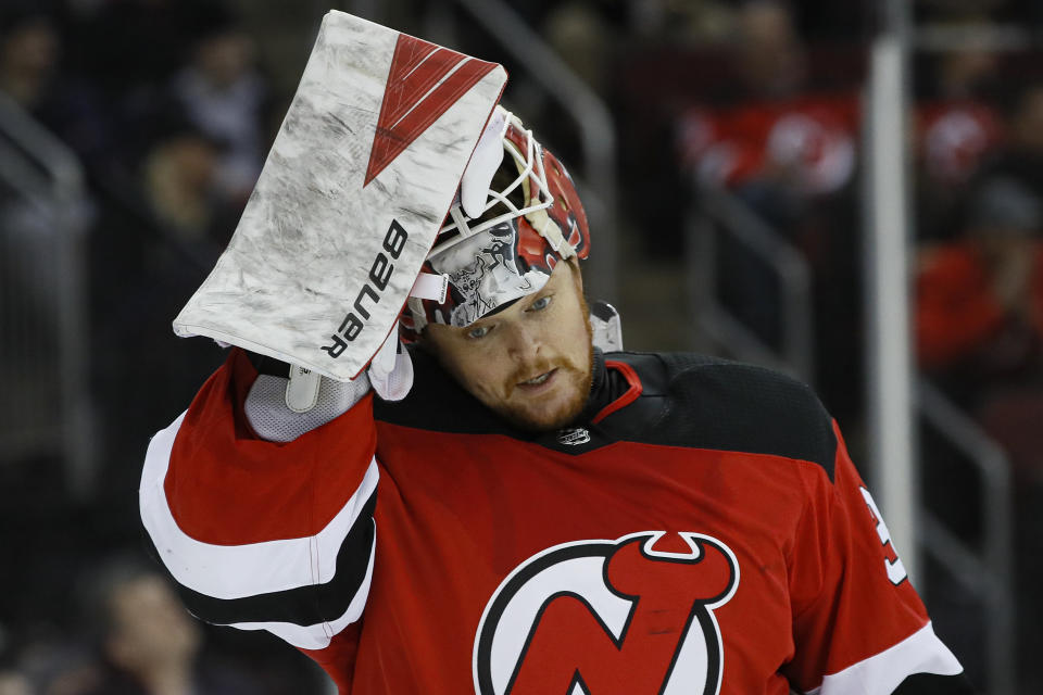 New Jersey Devils goaltender Cory Schneider reacts after giving up a goal to St. Louis Blues defenseman Vince Dunn during the first period of an NHL hockey game, Friday, March 6, 2020, in Newark. (AP Photo/John Minchillo)