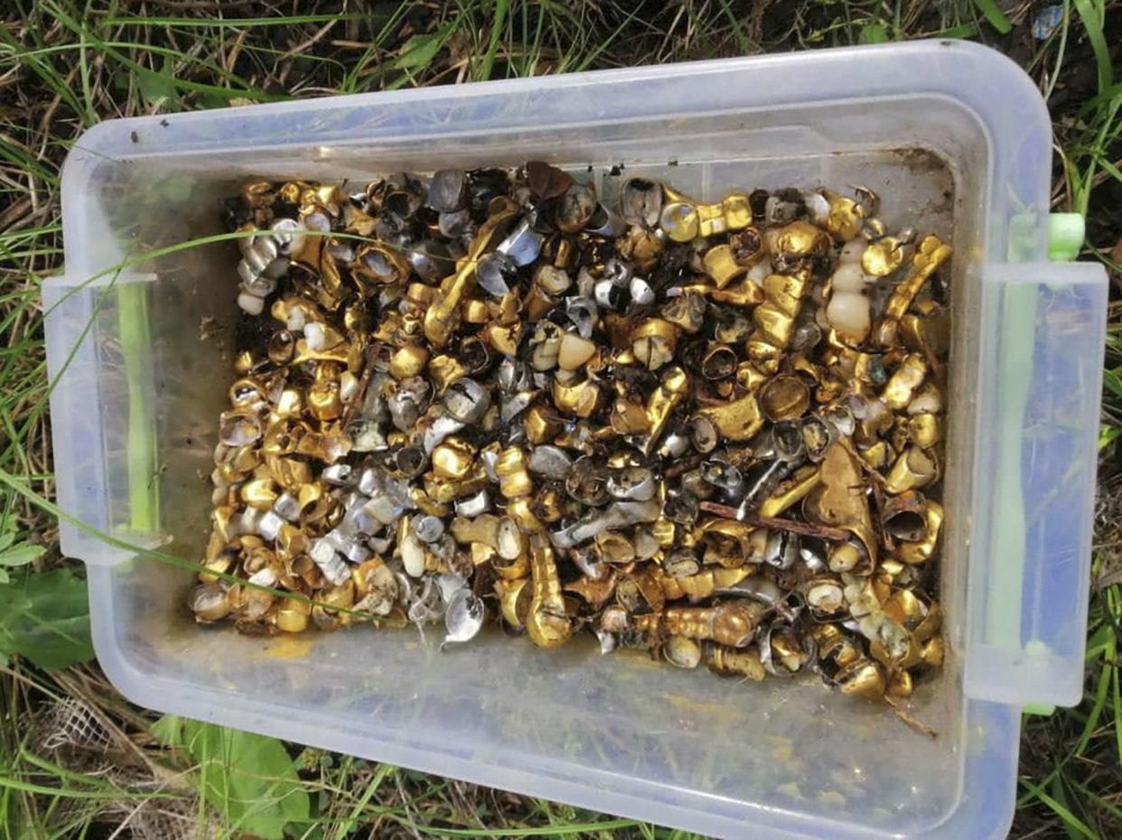 In this image released by the Police Press Service, dental crowns pulled out by the Russian troops from mouths of local residents and pows are seen in a box found in a torture chamber where the Russians reportedly tortured villagers and pows in the retaken village of Pisky-Radkivski in the Kharkiv region, Ukraine, Tuesday, Oct. 4, 2022.