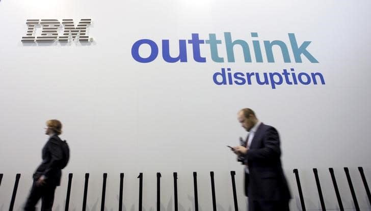 People walk past an IBM logo during the Mobile World Congress in Barcelona, Spain February 25, 2016. REUTERS/Albert Gea/File Photo