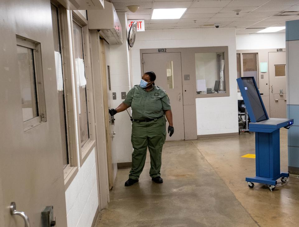 A corrections officer summons a new detainee who is to be processed Thursday, June 24, 2021, at the Allen County Jail in downtown Ft. Wayne, Ind.