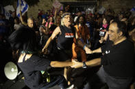 Israeli protesters dance and cheer during a demonstration against Israeli Prime Minister Benjamin Netanyahu outside his official residence in Jerusalem, Saturday, June 12, 2021. If all goes according to plan, Israel will swear in a new government on Sunday, ending Prime Minister Benjamin Netanyahu's record 12-year rule and a political crisis that inflicted four elections on the country in less than two years. (AP Photo/Ariel Schalit)