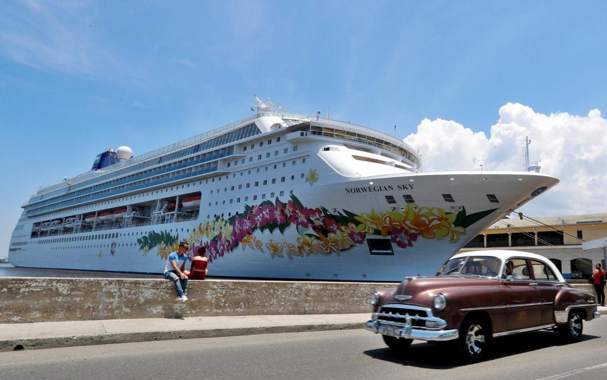 A classic car passes in front of the cruise terminal in Havana on June 4 - REX