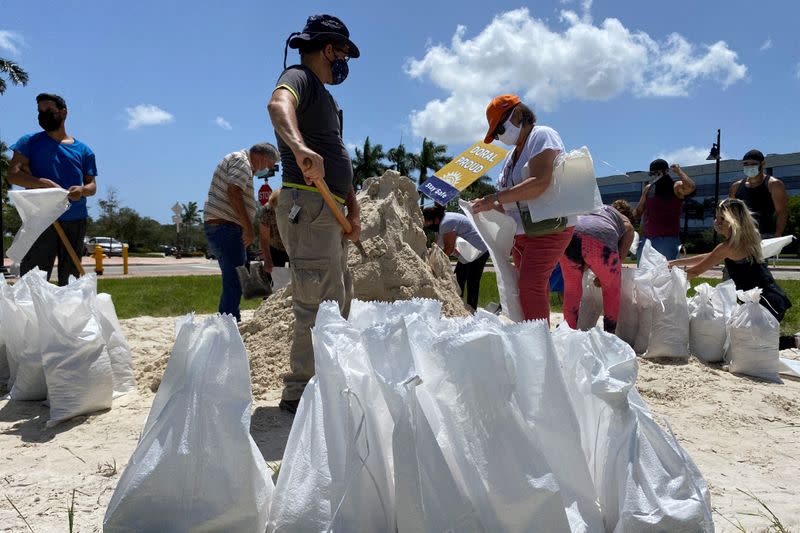 Residents fill and collect sand bags before the expected arrival of Hurricane Isaias in Doral