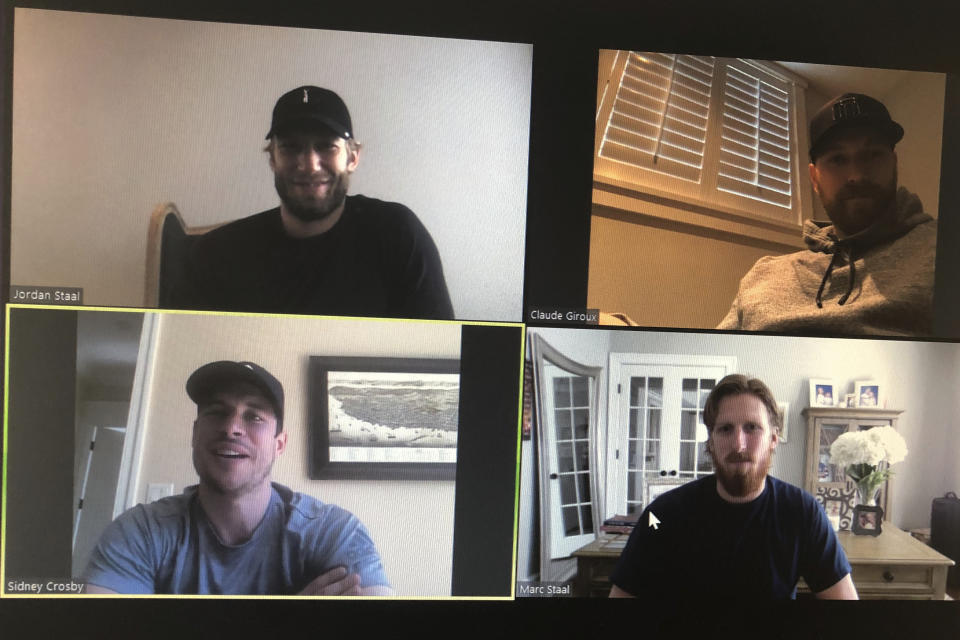 NHL hockey players Jordan Staal, captain of the Carolina Hurricanes, clockwise from top left, Claude Giroux, captain of the Philadelphia Flyers, Marc Stall, alternate captain for the New York Rangers and Sidney Crosby, captain of the Pittsburgh Penguins, take part in an NHL video call with players representing the Metropolitan Division Thursday, March 26, 2020, in this photo made in Buffalo, N.Y. (AP Photo/John Wawrow)