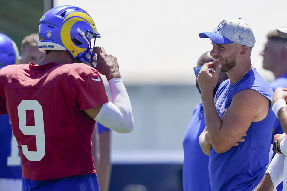 Los Angeles Rams wide receiver Cooper Kupp speaks with quarterback Matthew Stafford (9) during a joint NFL football practice with the Las Vegas Raiders, Wednesday, Aug. 16, 2023, in Thousand Oaks, Calif. (AP Photo/Ryan Sun)