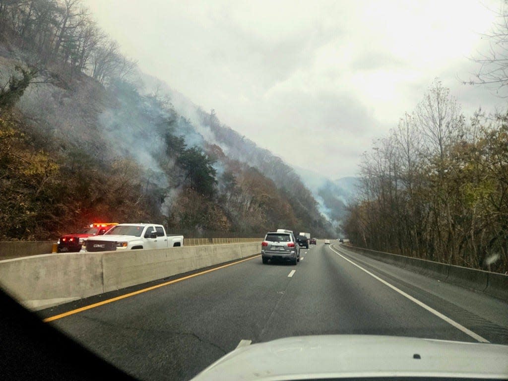 Trees and brush burn along the shoulder of I-40, as the Black Bear Fire grows to 1,193 acres Nov. 18.