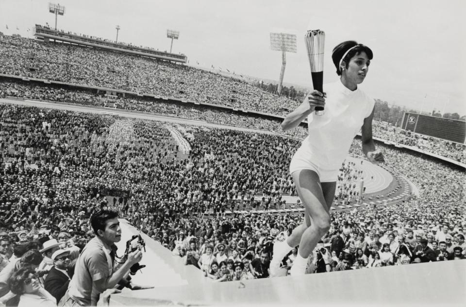 Mexico's Norma Enriqueta Basilio, the first woman in the history of the modern Olympic Games to light the Olympic Fire, runs up the ninety steps with the Olympic Torch during the opening ceremony.