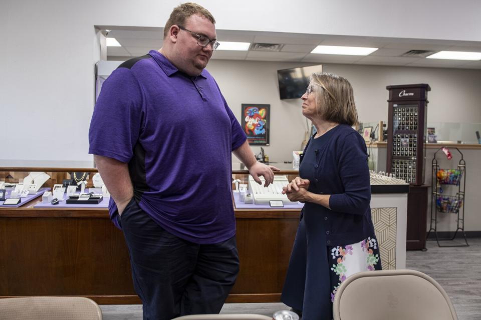 Laurens van Beek speaks with Rep. Mariannette Miller-Meeks during a meeting at the van Beek's parents jewelry store in Iowa.