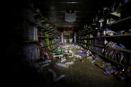 Damage is seen in a supermarket after it was looted during an ongoing blackout in Caracas, Venezuela March 10, 2019. REUTERS/Carlos Garcia Rawlins