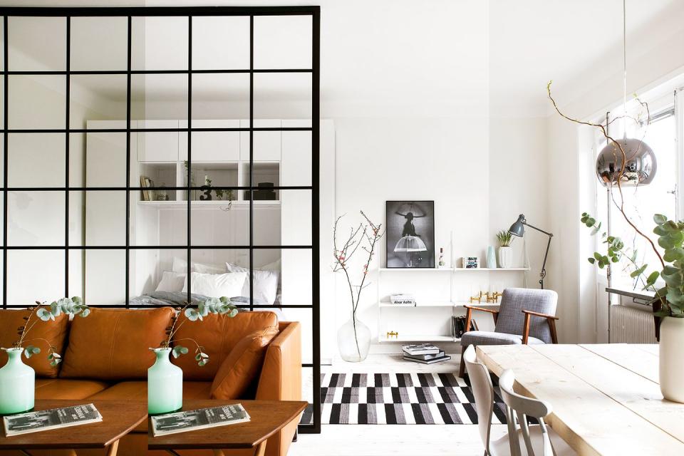 <p>The floating shelves in this neutral-toned Scandinavian studio apartment blend in seamlessly with the white walls. Take inspiration from this space if you're working within a smaller scale space and want your floating shelves to disappear instead of distract. </p>