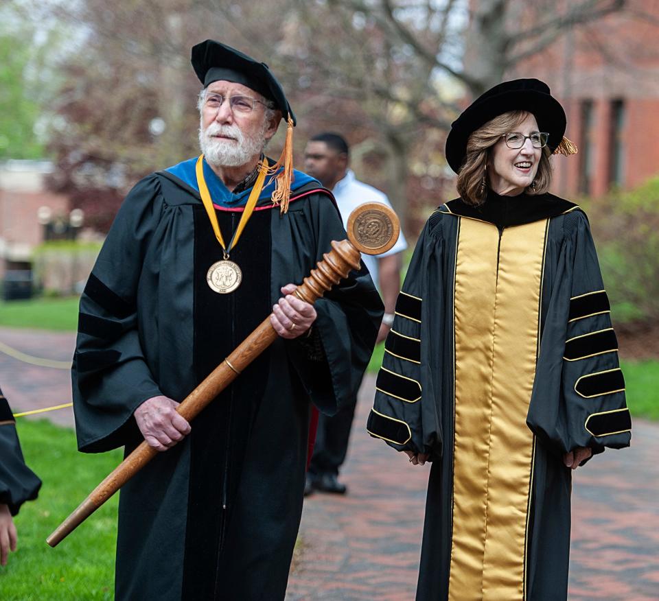 Nancy Niemi,  the 17th president of Framingham State University, processes to the inauguration May 5, 2023.  At left holding the ceremonial mace is Richard Beckwitt, professor of biology. 