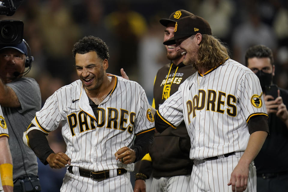 San Diego Padres' Trent Grisham, left, celebrates with teammate Josh Hader after hitting a walk-off home run during the ninth inning of the second baseball game of a doubleheader against the Colorado Rockies, Tuesday, Aug. 2, 2022, in San Diego. (AP Photo/Gregory Bull)