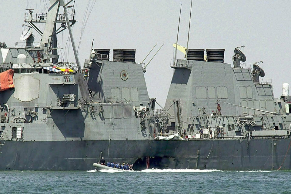 FILE - In this Oct. 15, 2000 file photo, experts in a speed boat examine the damaged hull of the USS Cole at the Yemeni port of Aden after an al-Qaida attack that killed 17 sailors. (AP Photo/Dimitri Messinis, File)