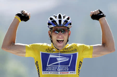 File Photo: U.S. Postal Service Team rider Lance Armstrong of the United States raises his arms as he crosses the finish line to win the 204.5 km long 17th stage of the Tour de France from Bourd-d'Oisans to Le Grand Bornand, France, July 22, 2004. REUTERS/Wolfgang Rattay/File Photo