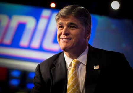 Fox News Channel anchor Sean Hannity poses for photographs as he sits on the set of his show "Hannity" at the Fox News Channel's studios in New York City, October 28, 2014. REUTERS/Mike Segar