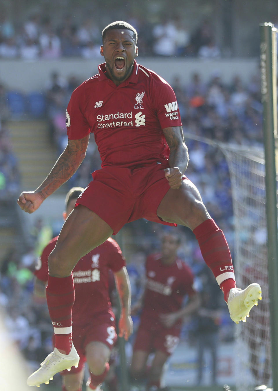 Liverpool's Georginio Wijnaldum celebrates scoring against Cardiff City during the English Premier League soccer match at The Cardiff City Stadium, Cardiff, Wales, Sunday April 21, 2019. (David Davies/PA via AP)