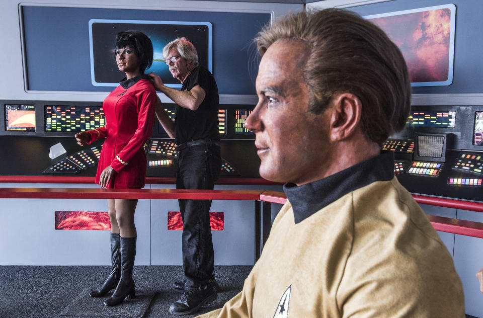 In this Saturday, March 25, 2017 photo, Steve Greenthal adjusts the wax head of Star Trek character Uhura on its body next to a figure of Captain Kirk at the Fullerton Airport in Fullerton, Calif. For many televisions watchers the kiss between Uhura and Kirk was the first interracial kiss seen on TV. The Hollywood Science Fiction Museum recently took possession of wax figures of all seven crew members from the 1960s "Star Trek" TV series. (Nick Agro/The Orange County Register via AP)