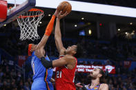 Oklahoma City Thunder forward Darius Bazley (7) blocks a shot by Portland Trail Blazers center Hassan Whiteside (21) in front of Thunder center Steven Adams, right, in the first half of an NBA basketball game Saturday, Jan. 18, 2020, in Oklahoma City. (AP Photo/Sue Ogrocki)