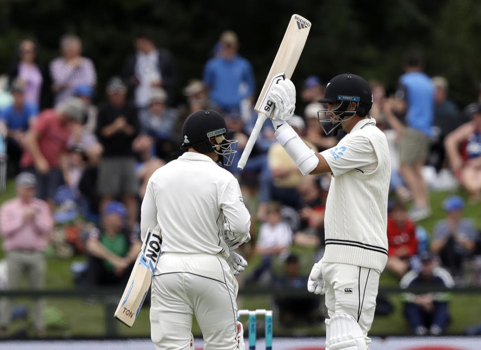 New Zealand's Tim Southee waves his bat as he celebrates after scoring 50 runs during play on day one of the second cricket test between New Zealand and Sri Lanka at Hagley Oval in Christchurch, New Zealand, Wednesday, Dec. 26, 2018. (AP Photo/Mark Baker)