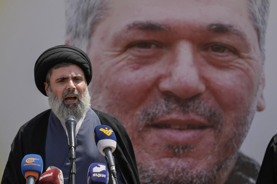 Senior Hezbollah leader Hashem Safieddine speaks during the funeral procession of Hezbollah senior commander Taleb Sami Abdullah, 55, known within Hezbollah as Hajj Abu Taleb, who was killed late Tuesday by an Israeli strike in south Lebanon, in the southern suburbs of Beirut, Lebanon, Wednesday, June 12, 2024. Hezbollah fired a massive barrage of rockets into northern Israel on Wednesday to avenge the killing of the top commander in the Lebanese militant group as the fate of an internationally-backed plan for a cease-fire in Gaza hung in the balance. (AP Photo/Bilal Hussein)