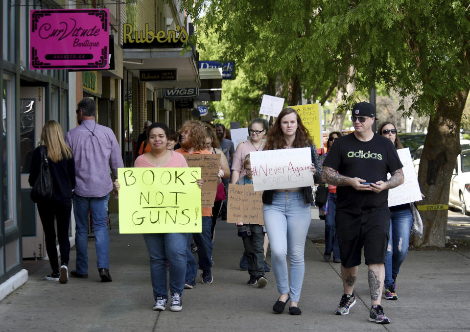 <p>Gun control protesters walk down Broad Street in downtown Augusta, Ga., Saturday morning March 24, 2018 as part of the March For Our Lives protests against gun violence. (Michael Holahan/The Augusta Chronicle/AP) </p>