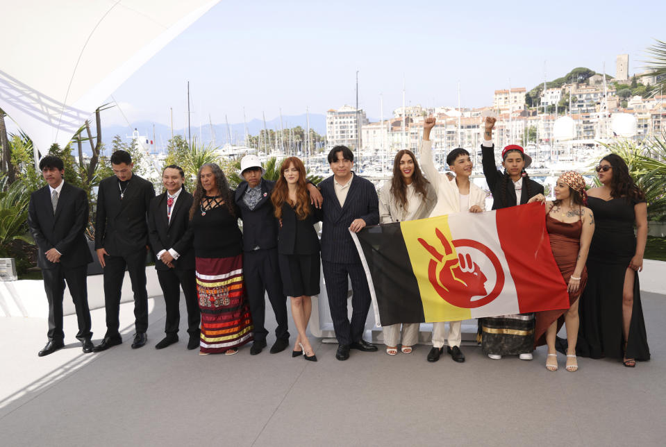 Manual Garcia, from left, Robert Stover Jr , Woodrow Long Elk, Wilma Colhoff, Ta-Yamni Long Black Cat, director Riley Keough, producer Willi White, director Gina Gammell, LaDainian Crazy Thunder, Jessica Poor Bear, Angelic McClung, and Calista Cottier pose for photographers at the photo call for the film 'War Pony' at the 75th international film festival, Cannes, southern France, Saturday, May 21, 2022. (Photo by Vianney Le Caer/Invision/AP)