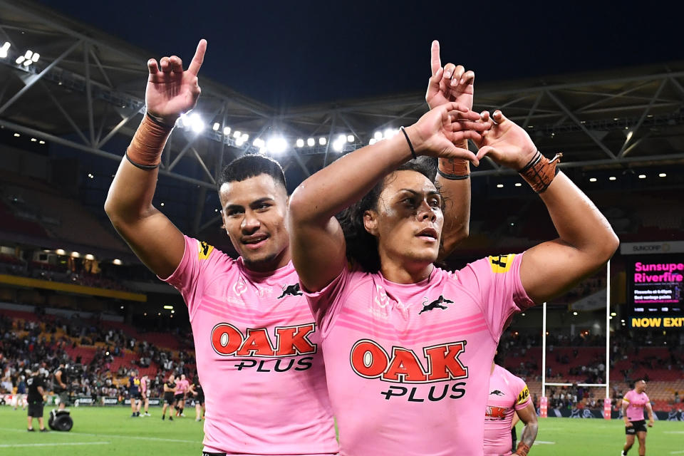 BRISBANE, AUSTRALIA - SEPTEMBER 25: Stephen Crichton and Jarome Luai of the Panthers wave to the crowd as they celebrate victory during the NRL Preliminary Final match between the Melbourne Storm and the Penrith Panthers at Suncorp Stadium on September 25, 2021 in Brisbane, Australia. (Photo by Bradley Kanaris/Getty Images)