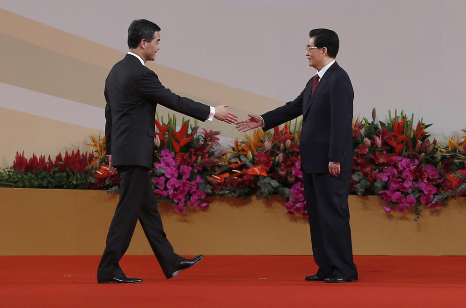 Chinese President Hu Jintao, right, shakes hands with Hong Kong's new Chief Executive Leung Chun-ying after Leung was sworn in, at the Hong Kong Convention and Exhibition Center in Hong Kong Sunday, July 1, 2012. Hong Kong's new Beijing-backed leader was sworn in on Sunday amid a rising tide of public discontent over widening inequality and lack of full democracy in the semiautonomous southern Chinese financial center. (AP Photo/Vincent Yu)