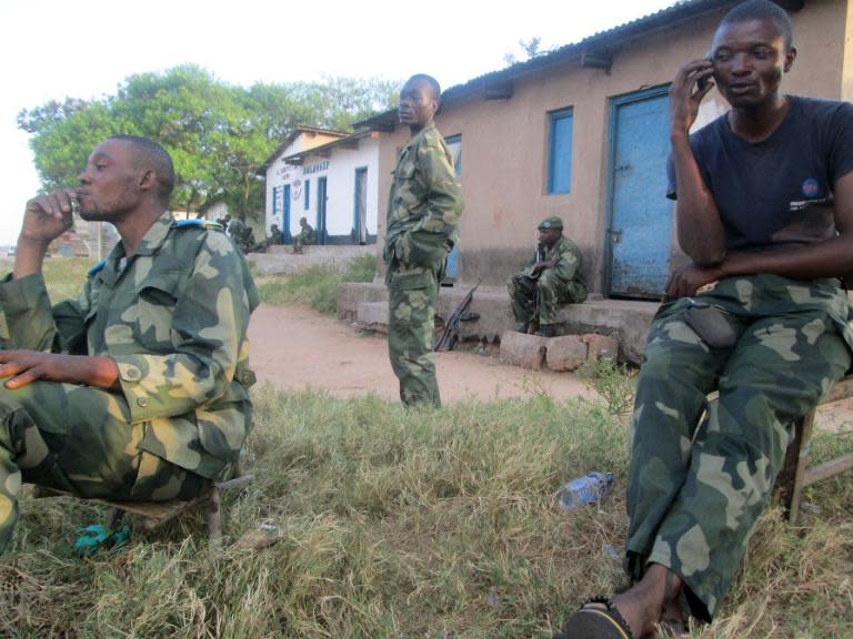 Democratic Republic of Congo soldiers stand guard in Mutarule, near Sange, South Kivu, on June 10, 2014