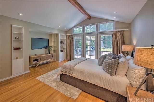 <p>Here’s another bedroom, this one with even more natural light and larger French doors. <br>(Realtor.com) </p>