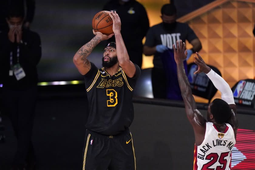 Los Angeles Lakers' Anthony Davis (3) takes a shot as Miami Heat's Kendrick Nunn (25) defends during the first half of Game 2 of basketball's NBA Finals, Friday, Oct. 2, 2020, in Lake Buena Vista, Fla. (AP Photo/Mark J. Terrill)