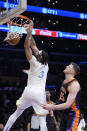 Los Angeles Lakers forward Anthony Davis (3) dunks past New York Knicks center Isaiah Hartenstein during the first half of an NBA basketball game Sunday, March 12, 2023, in Los Angeles. (AP Photo/Marcio Jose Sanchez)