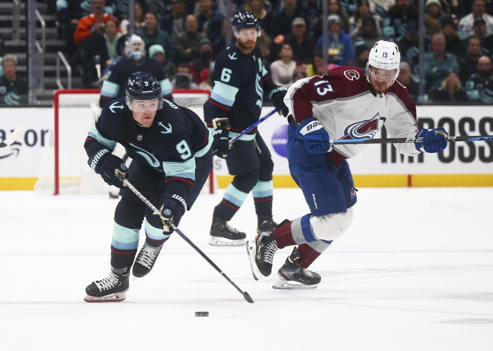 Seattle Kraken center Ryan Donato (9) is defended by Colorado Avalanche right wing Valeri Nichushkin (13) during the second period of an NHL hockey game Saturday, Jan. 21, 2023, in Seattle. (AP Photo/Lindsey Wasson)