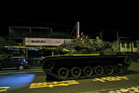 In this photo released by the Military News Agency, a tank prepares to take part in the annual Han Kuang live-fire drills in Hualian, eastern Taiwan in the early hours of Tuesday, Sept. 14, 2021. (Military News Agency via AP)