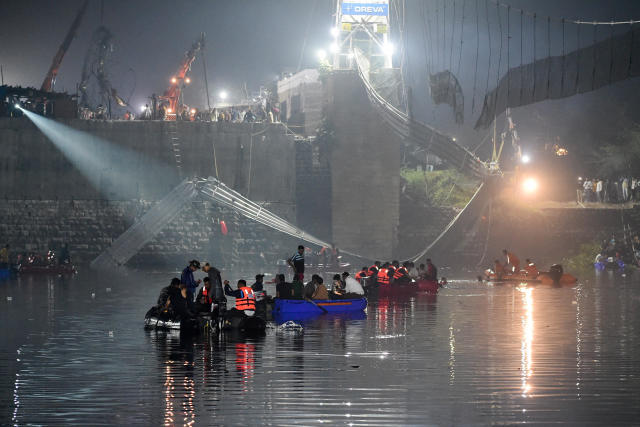 Indian rescue personnel conduct search operations after a bridge across the river Machchhu collapsed in Morbi, some 120 miles from Ahmedabad, early on October 31, 2022. / Credit: SAM PANTHAKY/AFP/Getty