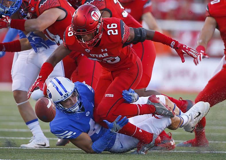 SALT LAKE CITY, UT - SEPTEMBER 10: Terrell Burgess #26 of the Utah Utes fumbles the ball after he was hit by Alema Pilimai #45 of the Brigham Young Cougars during the first half of an college football game, at Rice Eccles Stadium on September 10, 2016 in Salt Lake City, Utah. (Photo by George Frey/Getty Images)